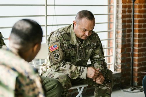 A therapy session focusing on mental health support among military veterans.