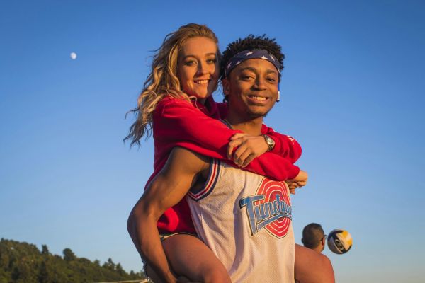 A cheerful couple enjoying a sunny day together outdoors, showing joy and happiness.